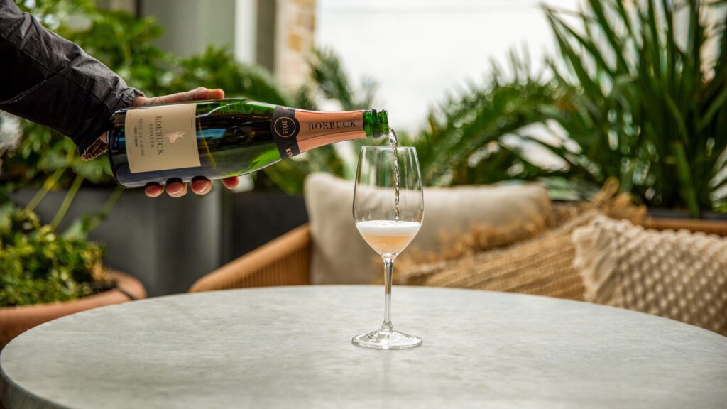 Roebuck Estates Rose de Noirs being poured into a champagne flute.