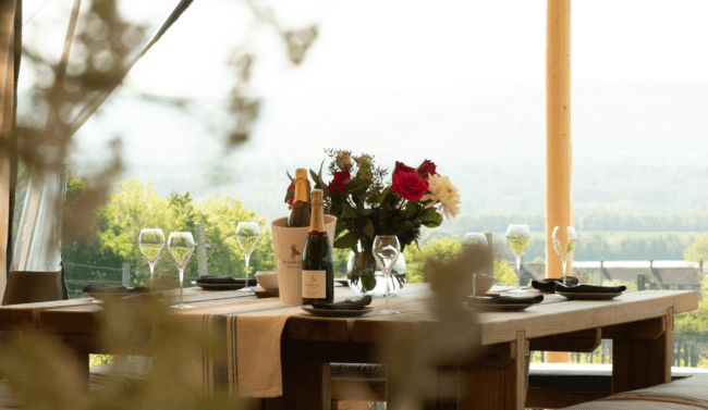 Untitled design (100) Dining table with wine glasses on it.