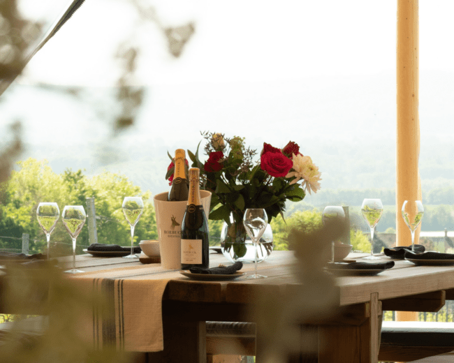 Dining table with wine glasses on it.