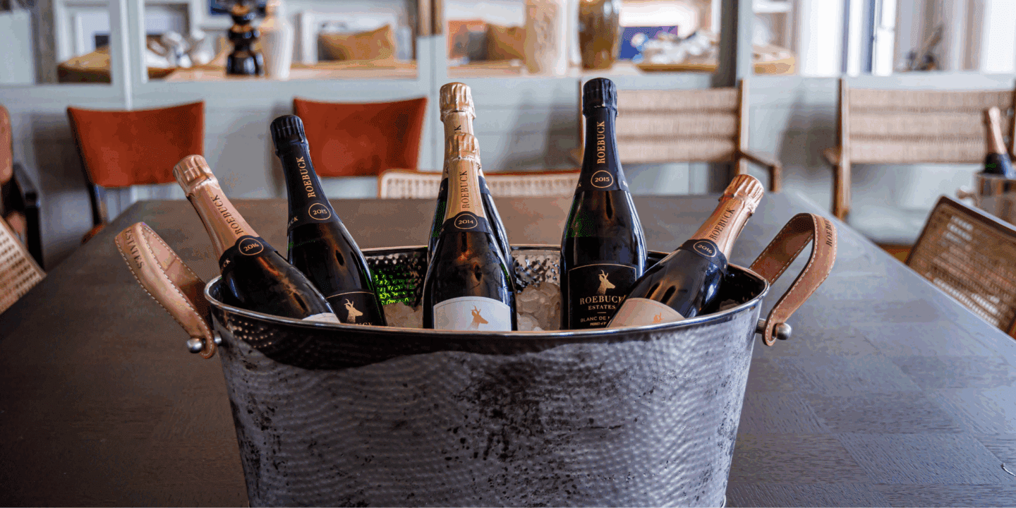 Selection of Roebuck Estates sparkling wines in large silver ice bucket in home